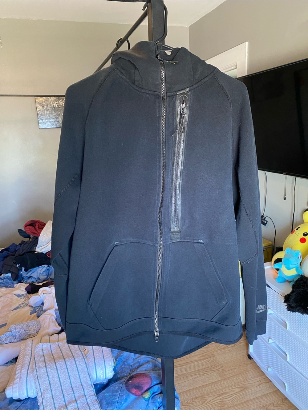 Nike Black Tech Fleece Full-Zip Hoodie with left chest zipper pockets.